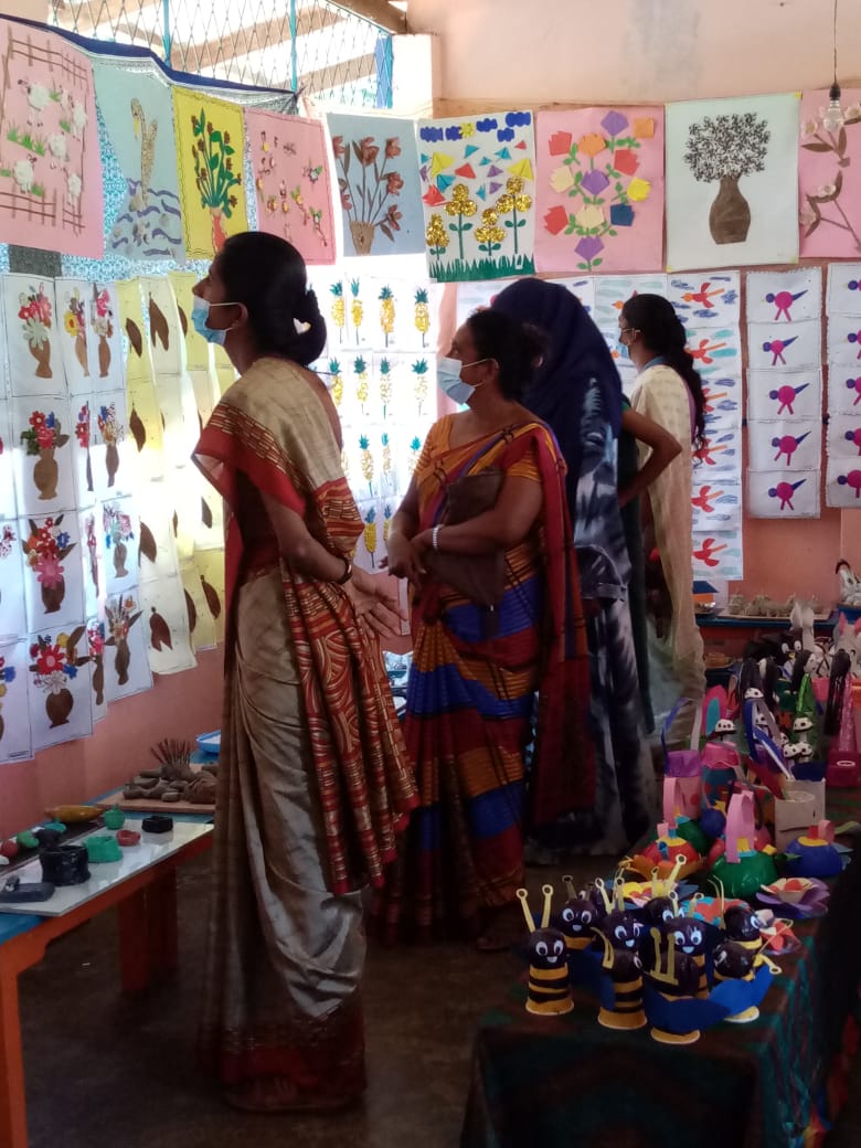 Five cats looking around a field.